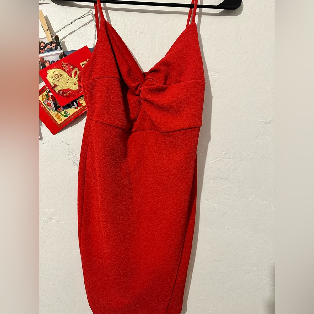 Spaghetti strap red dress. Slight slit at thigh.